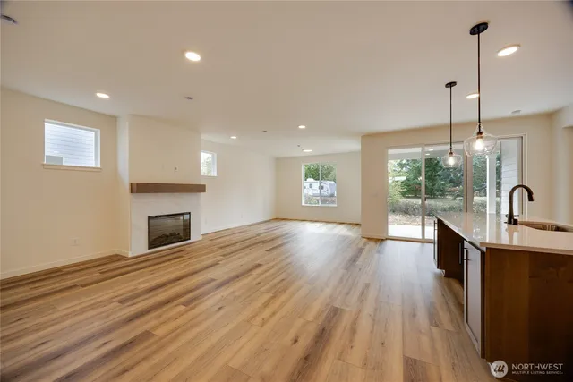 a view of a kitchen with a sink and a fireplace