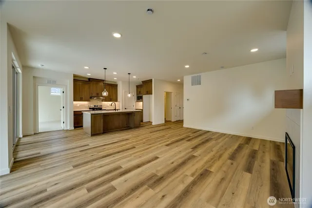 a large kitchen with kitchen island a sink stainless steel appliances and cabinets