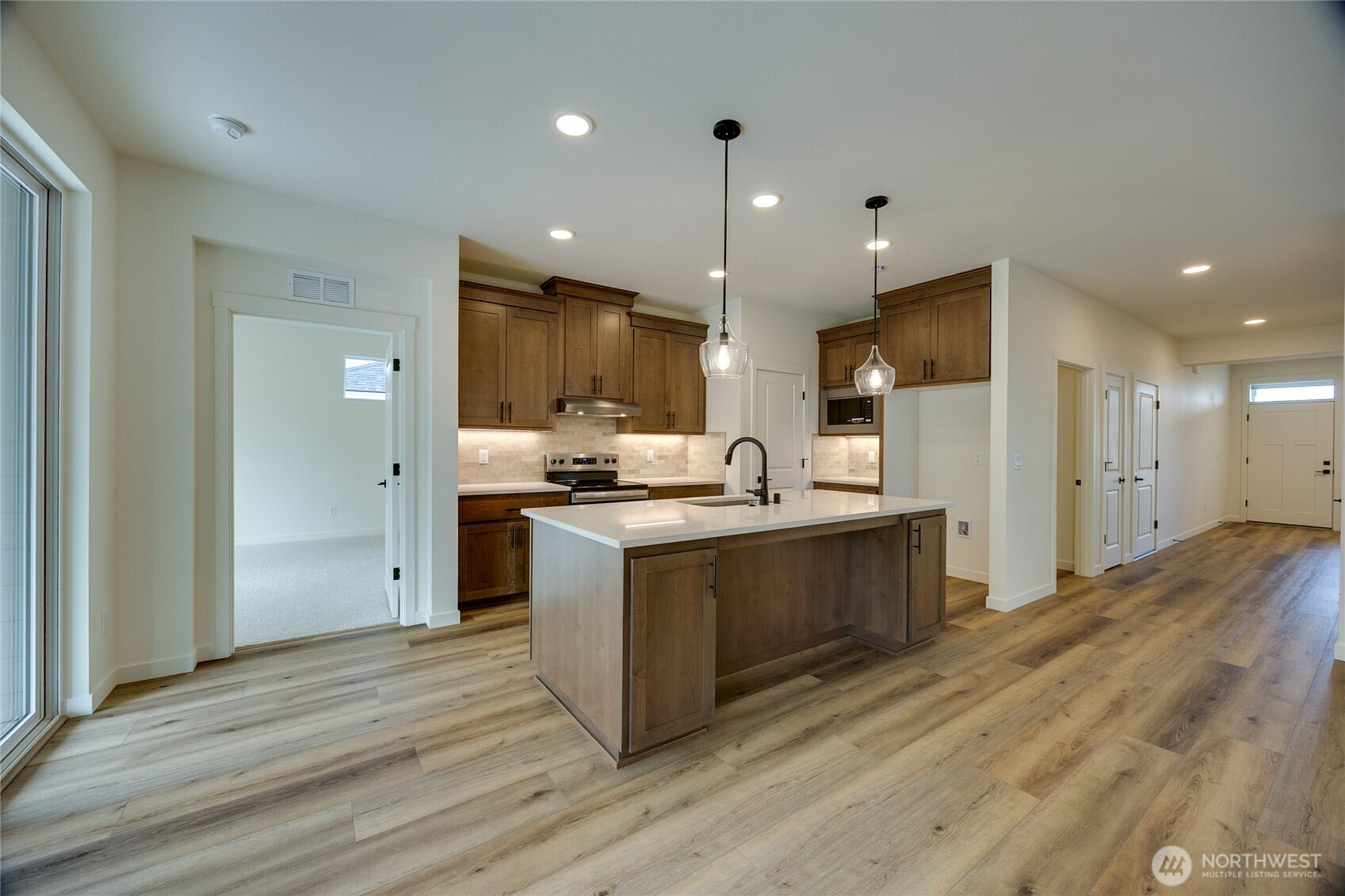 930 RW Fletcher Street Winlock, WA 98596 - Photo 24 of 40 a kitchen with stainless steel appliances kitchen island wooden cabinets and granite counter tops