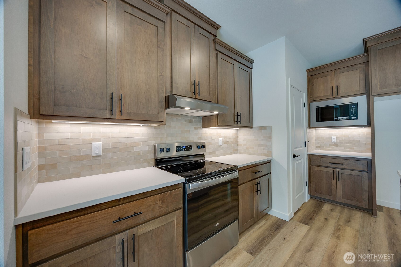 930 RW Fletcher Street Winlock, WA 98596 - Photo 31 of 40 a kitchen with cabinets wooden floor and stainless steel appliances