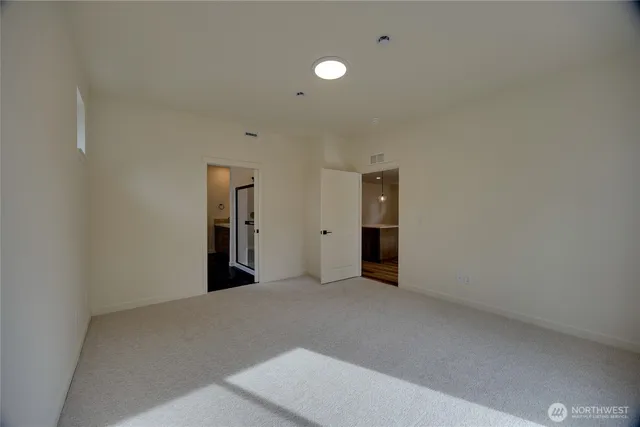 an empty room with windows and closet