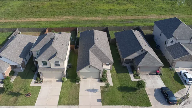 an aerial view of a house with outdoor space lake view and seating space