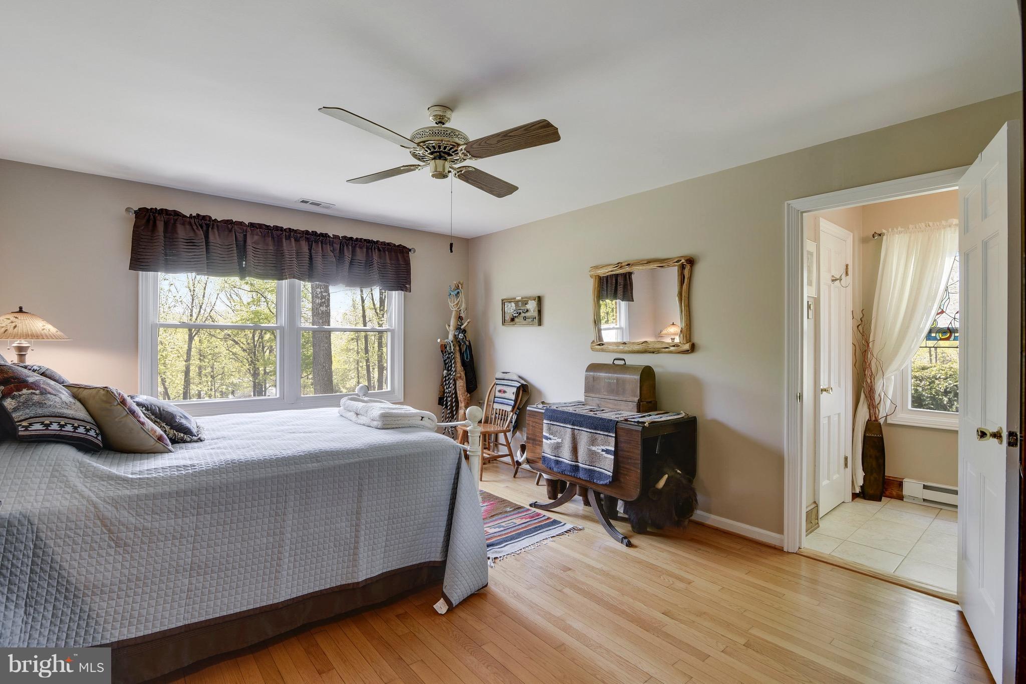 7142 Waterford Road Rixeyville, VA 22737 - Photo 14 of 25 a bedroom with a bed and wooden floor