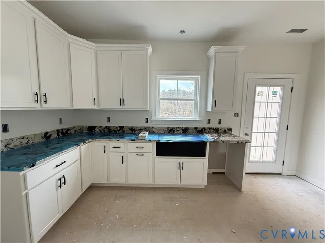 a view of a kitchen with a sink and window