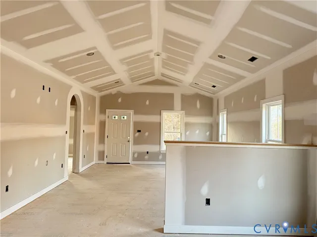 a kitchen with stainless steel appliances granite countertop a stove a refrigerator a sink dishwasher and white cabinets with wooden floor