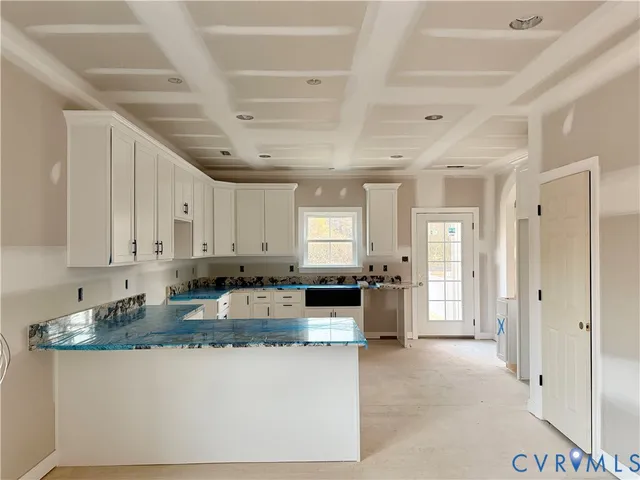 a large kitchen with stainless steel appliances granite countertop a sink and cabinets