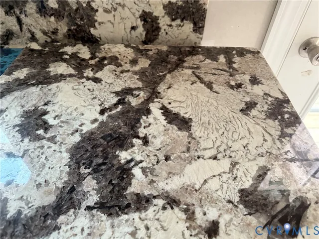 a large white kitchen with cabinets