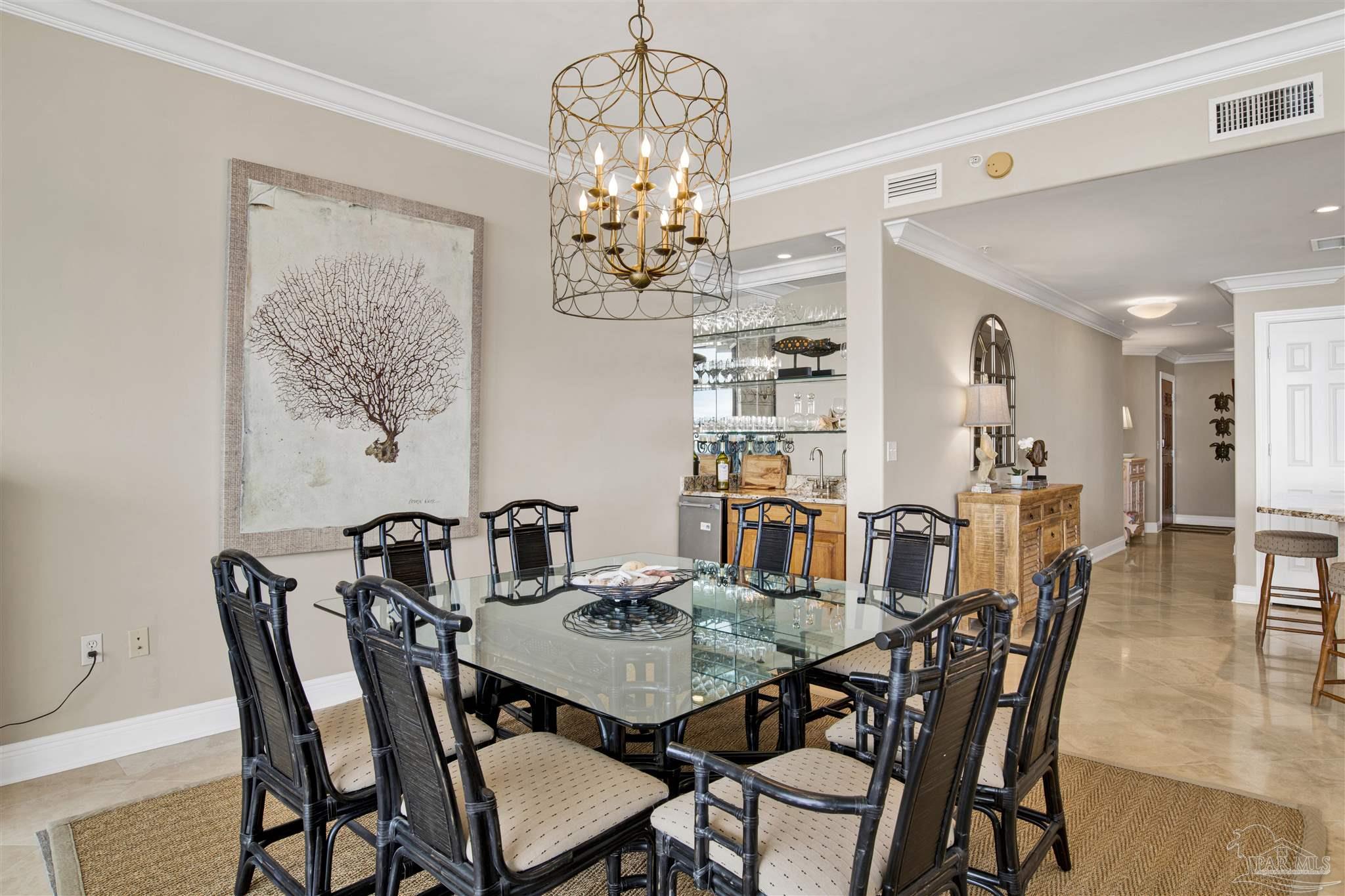 16547 Perdido Key Drive, Unit E501 Pensacola, FL 32507 - Photo 12 of 63 a view of a dining room with furniture a chandelier and wooden floor