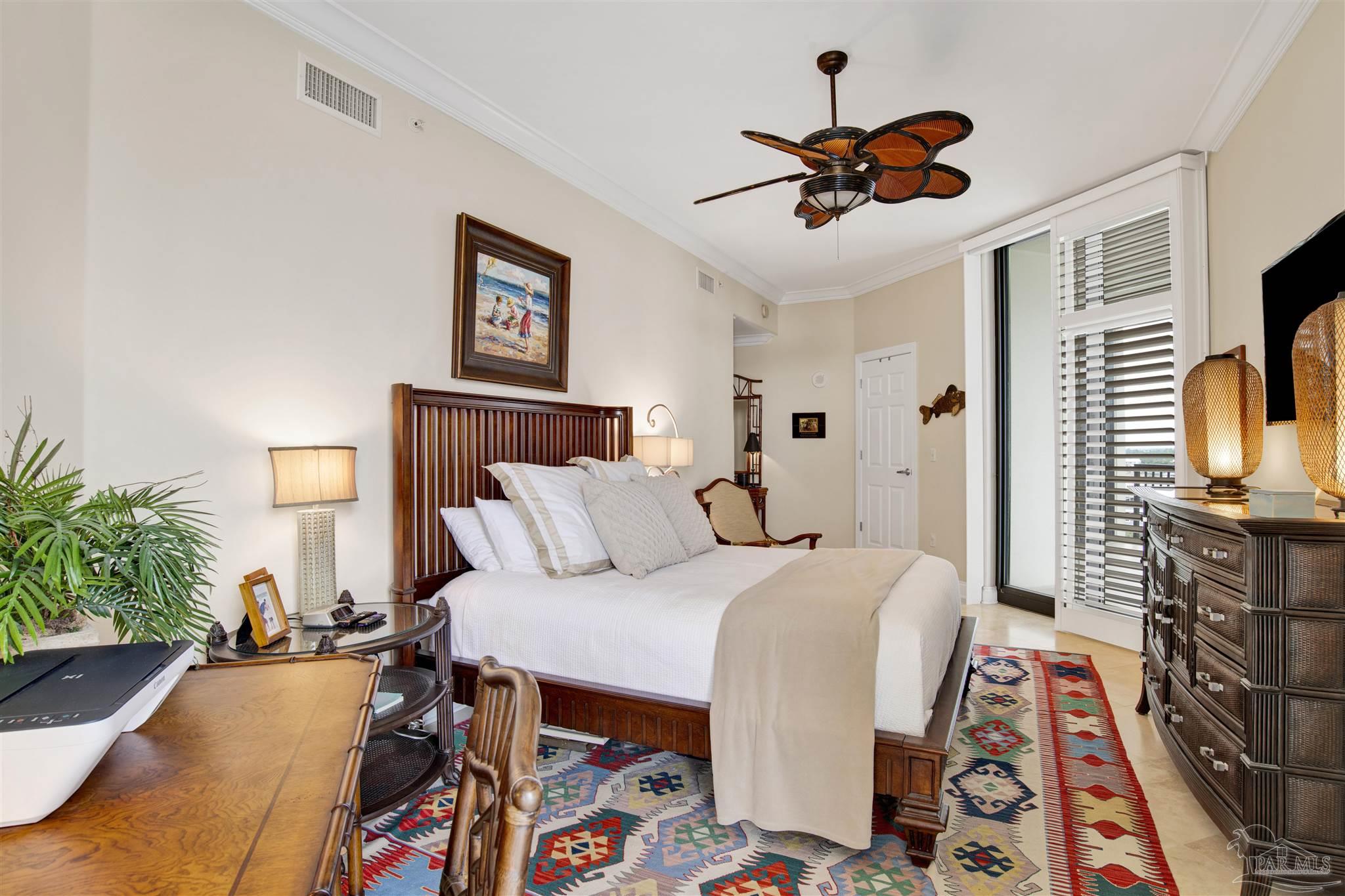 16547 Perdido Key Drive, Unit E501 Pensacola, FL 32507 - Photo 19 of 63 a bedroom with a bed and a chandelier