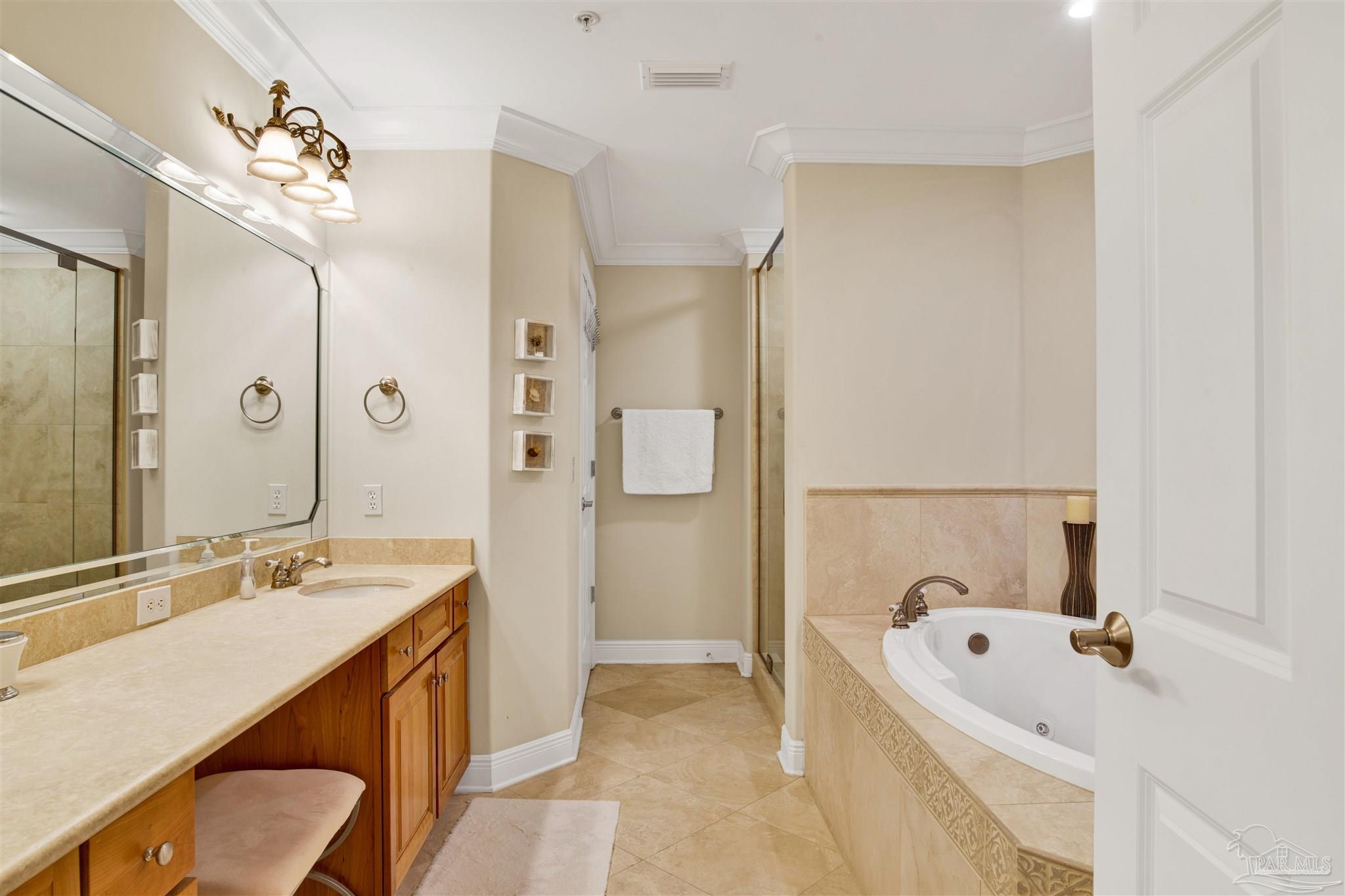 16547 Perdido Key Drive, Unit E501 Pensacola, FL 32507 - Photo 22 of 63 a bathroom with a tub a sink and a mirror