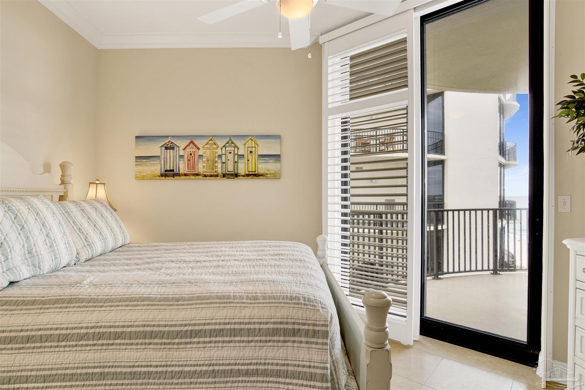 16547 Perdido Key Drive, Unit E501 Pensacola, FL 32507 - Photo 27 of 63 a bedroom with a bed and a painting on the wall