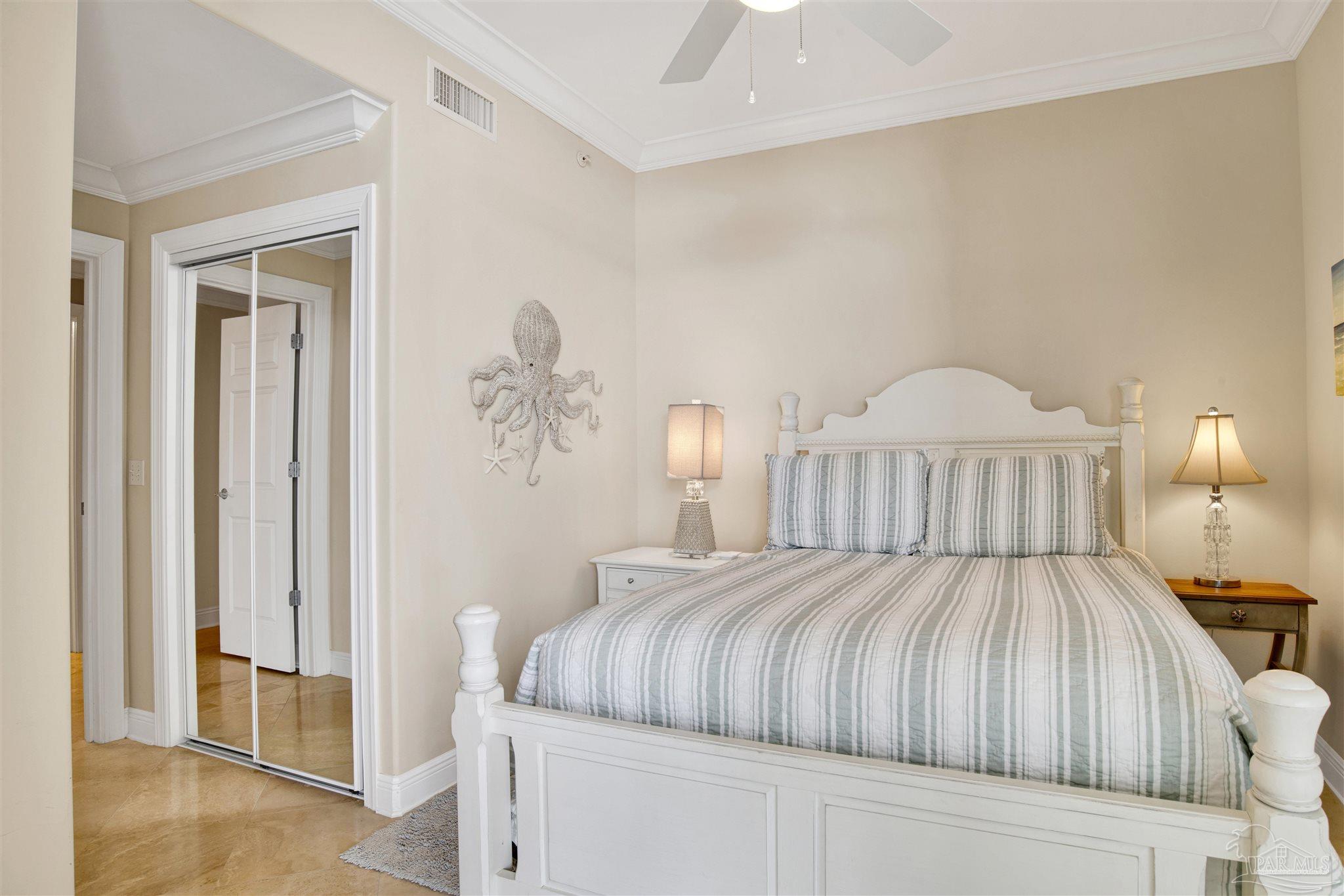 16547 Perdido Key Drive, Unit E501 Pensacola, FL 32507 - Photo 28 of 63 a bedroom with a large bed and a chandelier