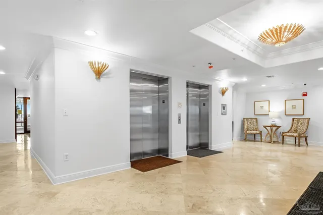 a view of a balcony with potted plants and wooden fence