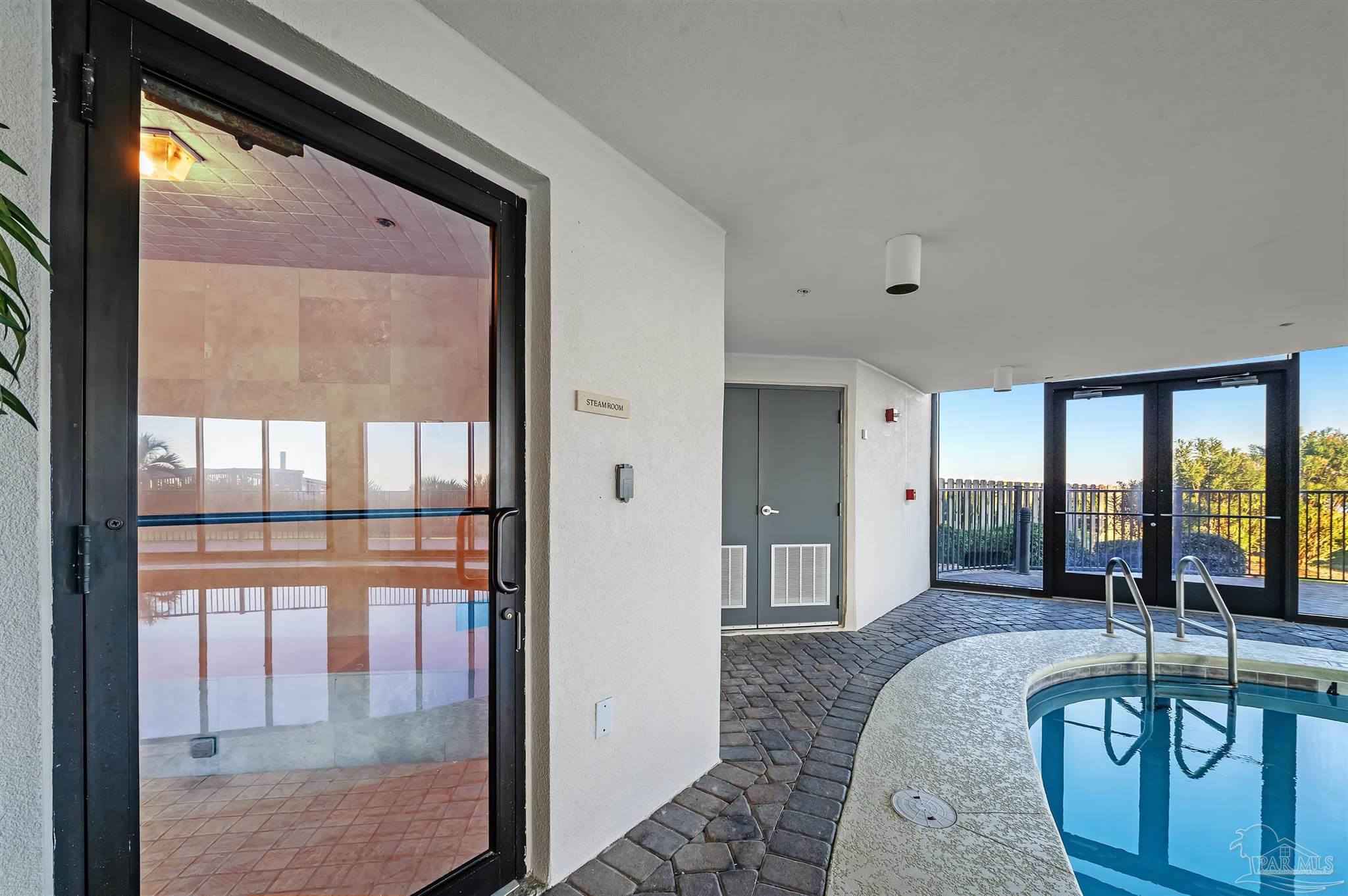 16547 Perdido Key Drive, Unit E501 Pensacola, FL 32507 - Photo 46 of 63 a living room with furniture and a floor to ceiling window