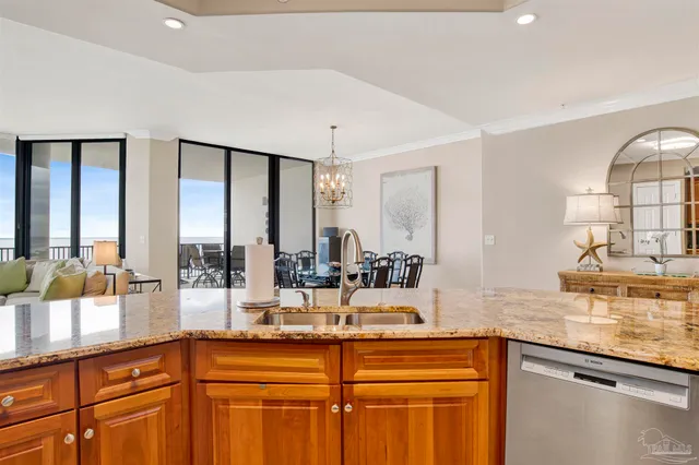 a view of a dining room with furniture a chandelier and wooden floor