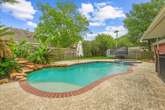 a view of a swimming pool with a backyard