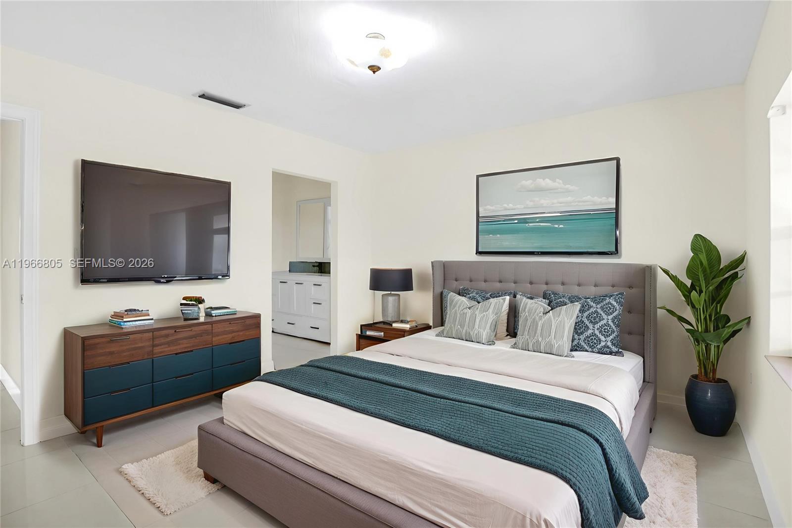 13844 Southwest 15th Street Miami, FL 33184 - Photo 11 of 31 a bedroom with a large bed and a flat screen tv