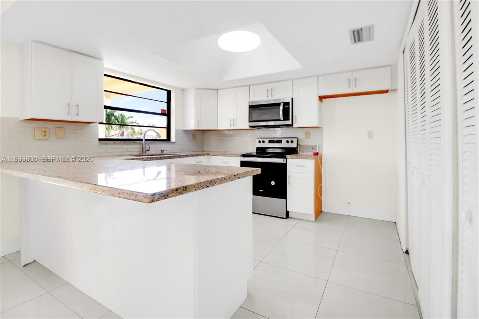 13844 Southwest 15th Street Miami, FL 33184 - Photo 21 of 31 a kitchen with stainless steel appliances granite countertop a stove a sink and a refrigerator
