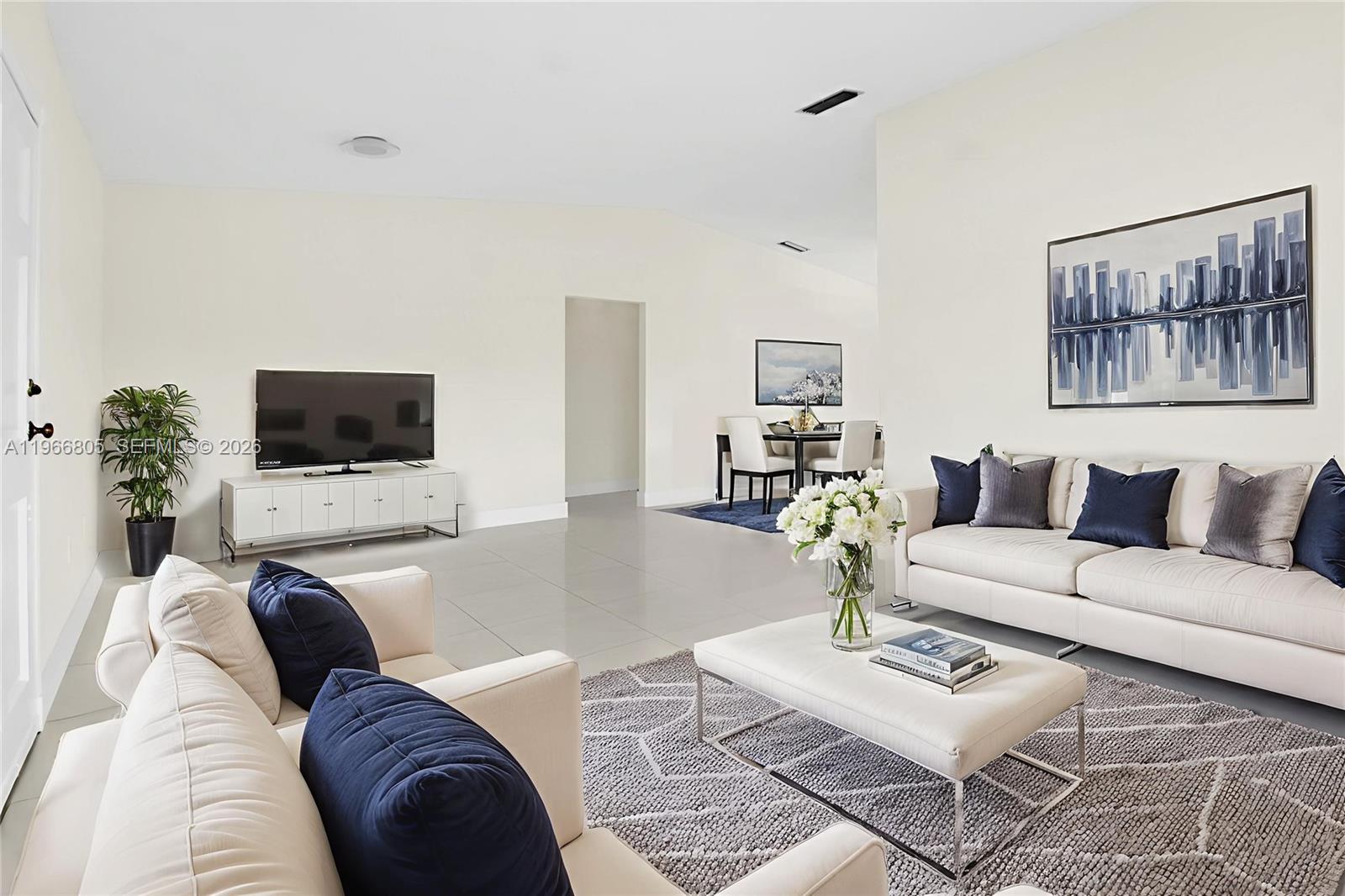 13844 Southwest 15th Street Miami, FL 33184 - Photo 3 of 31 a living room with furniture and a flat screen tv