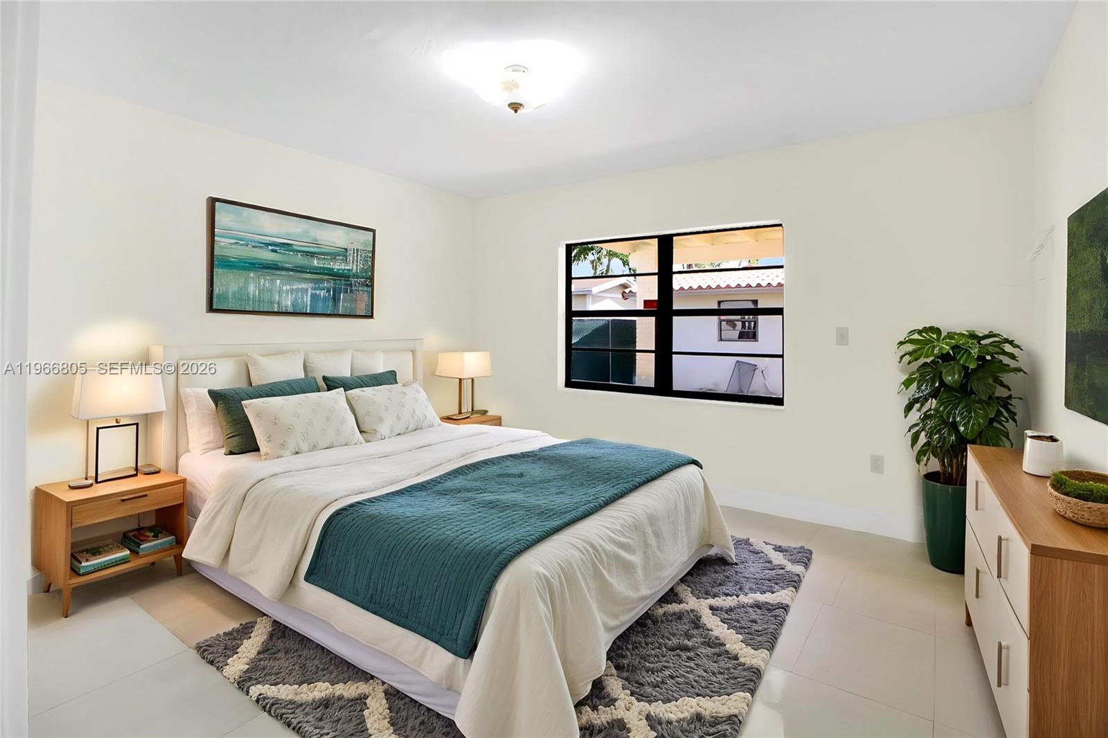 13844 Southwest 15th Street Miami, FL 33184 - Photo 7 of 31 a bedroom with a large bed and a potted plant