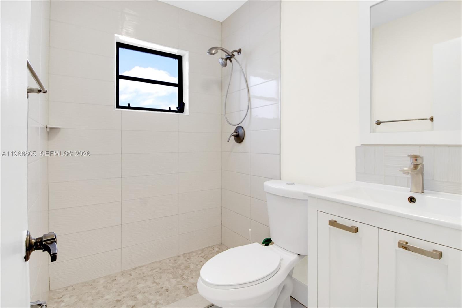 13844 Southwest 15th Street Miami, FL 33184 - Photo 10 of 31 a bathroom with a sink a toilet and shower