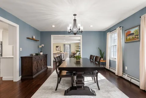 a dining room with furniture window and wooden floor