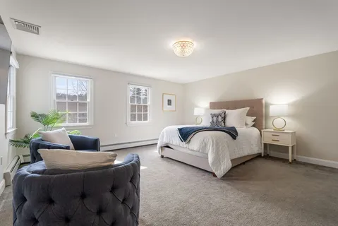 a bedroom with bed and a couch