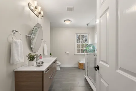 a bathroom with a sink a mirror and a shower