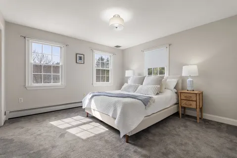 a spacious bedroom with a bed and a window