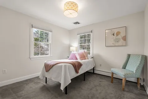 a bed room with a bed and a chair