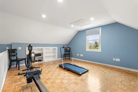 a room with gym equipment and a wooden floor