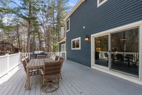 a view of a patio with table and chairs and wooden floor
