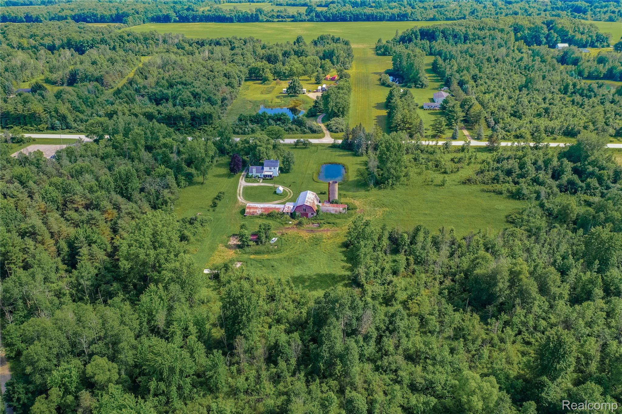 8384 Imlay City Road Avoca, MI 48006 - Photo 6 of 39 Expansive property featuring a central residence, a red barn, and a silo