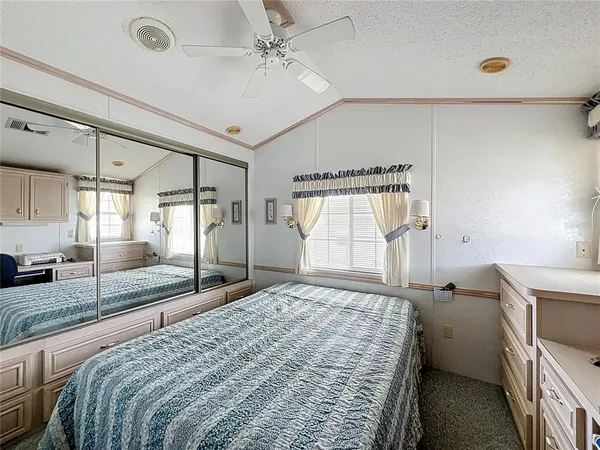 a bedroom with a bed and a large window