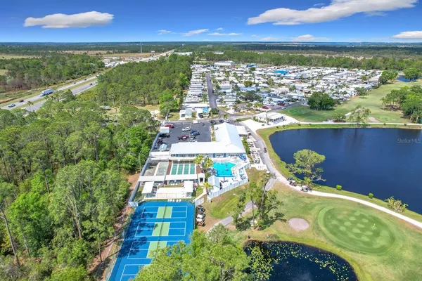 an aerial view of a residential houses with outdoor space and swimming pool