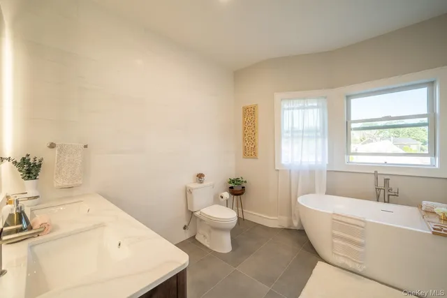 a bathroom with a sink a toilet and tub