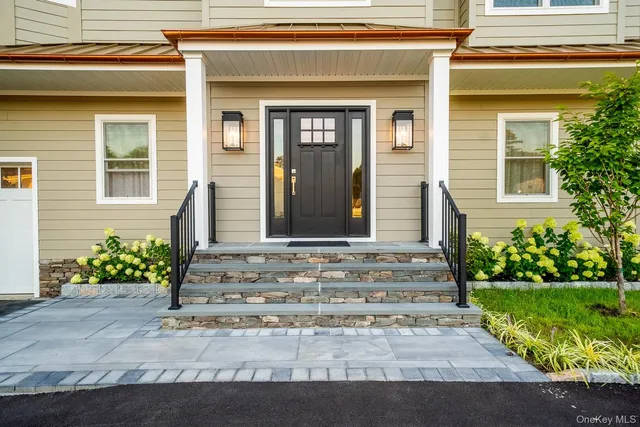 a front view of a house with garden