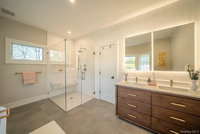 a bathroom with a double vanity sink mirror and double