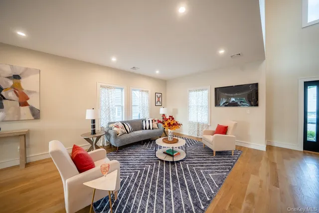 a living room with furniture or couch and a wooden floor