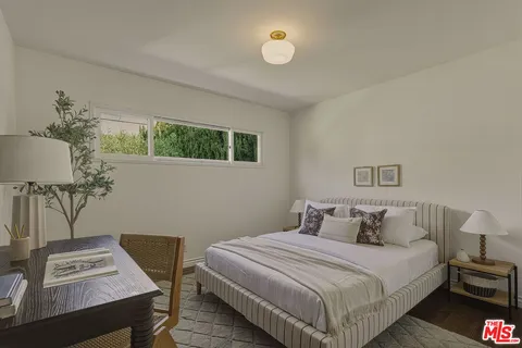 a bedroom with a bed a desk and chair