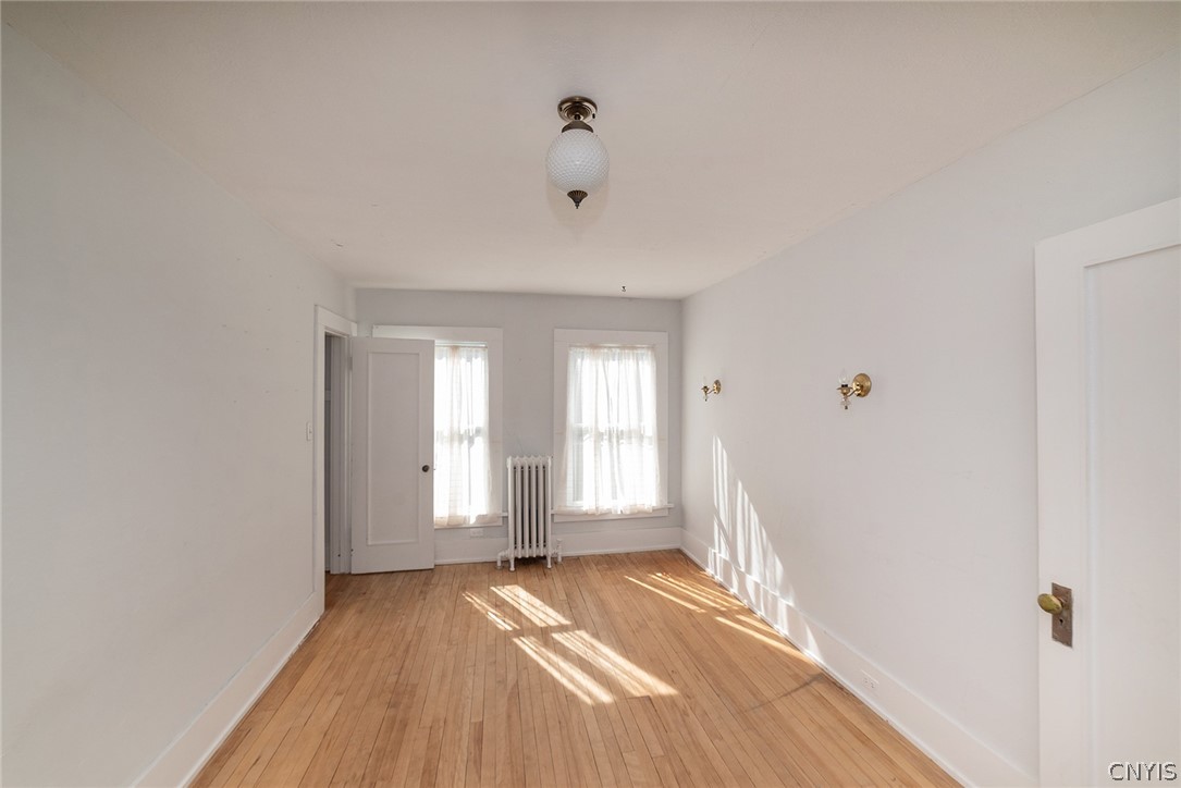 167 Beverly Road Syracuse, NY 13207 - Photo 32 of 50 Hardwood floors and deep-set windows define this versatile, light-filled interior space.