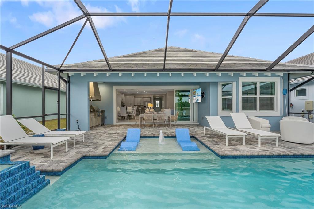8795 Calypso Court Naples, FL 34113 - Photo 29 of 49 a view of a dinning table and chairs in the patio