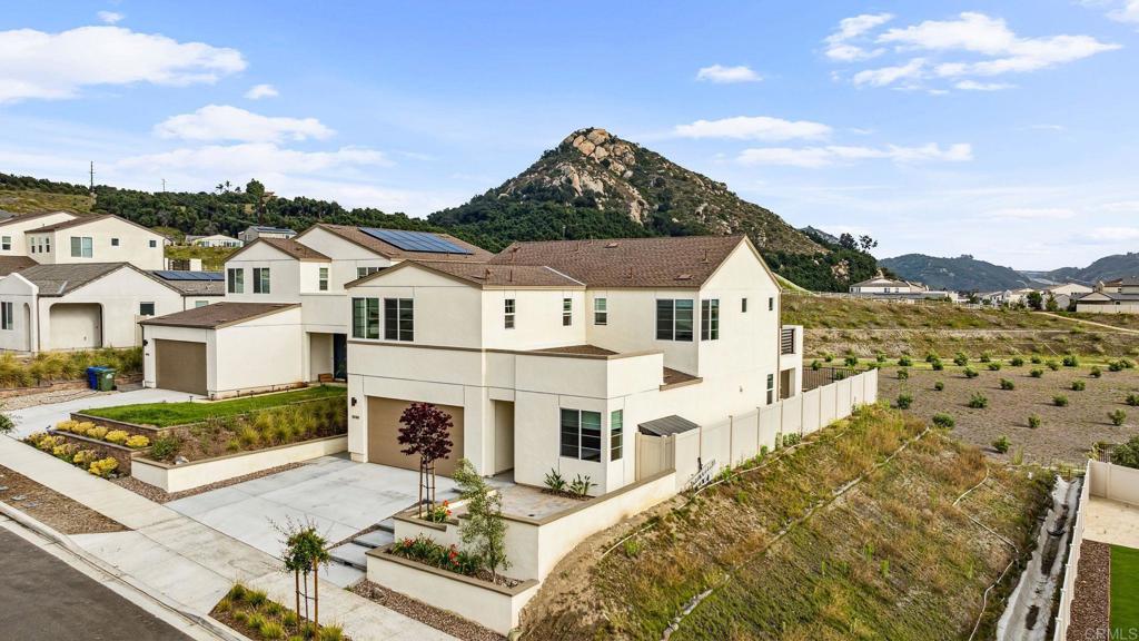 a view of a white house with a yard