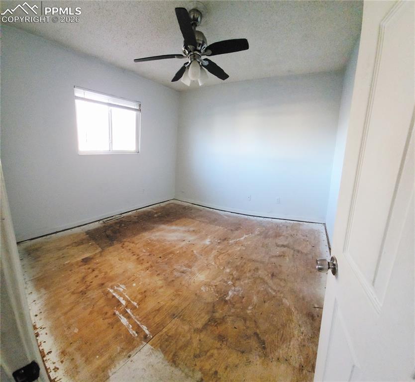 1214 Burnham Street Colorado Springs, CO 80906 - Photo 5 of 11 an empty room with a window and a ceiling fan