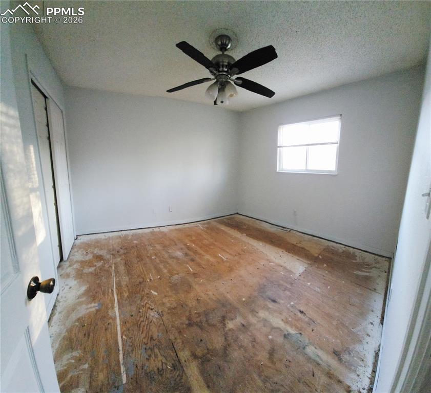 1214 Burnham Street Colorado Springs, CO 80906 - Photo 6 of 11 a view of a livingroom with a ceiling fan and wooden floor