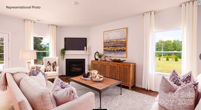 a living room with furniture a window and a fireplace