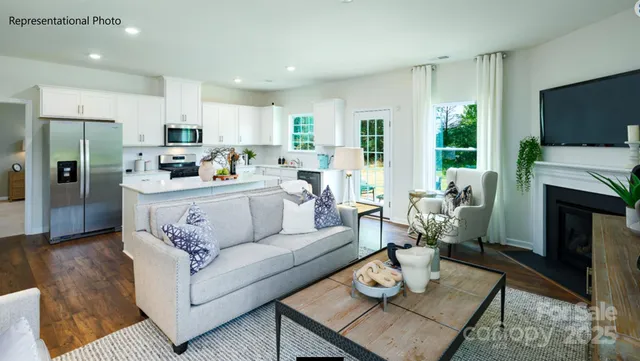 a living room with fireplace furniture and a flat screen tv