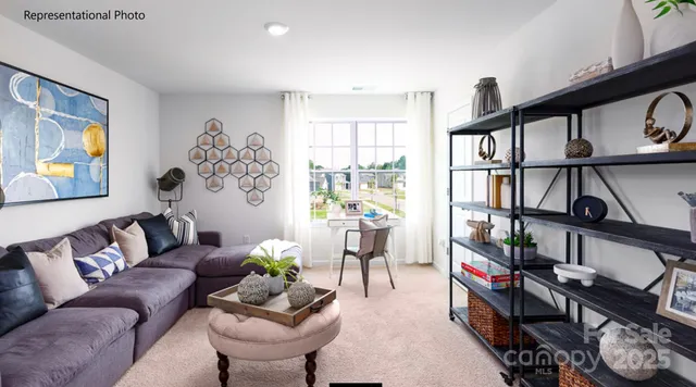 a living room with furniture a bookshelf and a window
