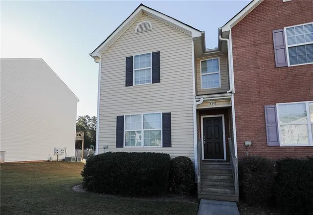 a front view of a house with a yard