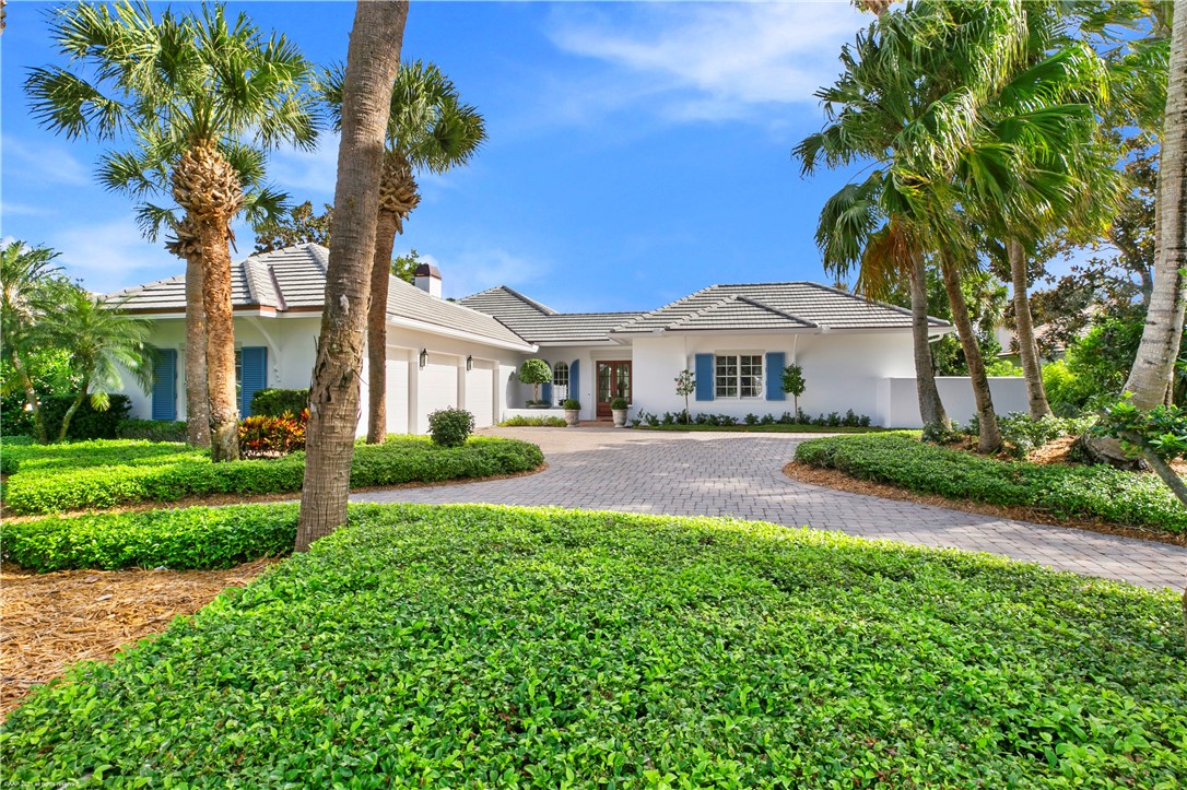 902 Orchid Point Way Vero Beach, FL 32963 - Photo 3 of 5 a front view of a house with a yard and garage